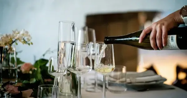 Sommelier pours Tasmanian white wine in preparation for a long lunch in a Tamar Valley winery