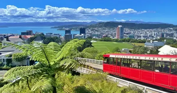 Iconic red Wellington Cable Car glides above the Wellington skyline