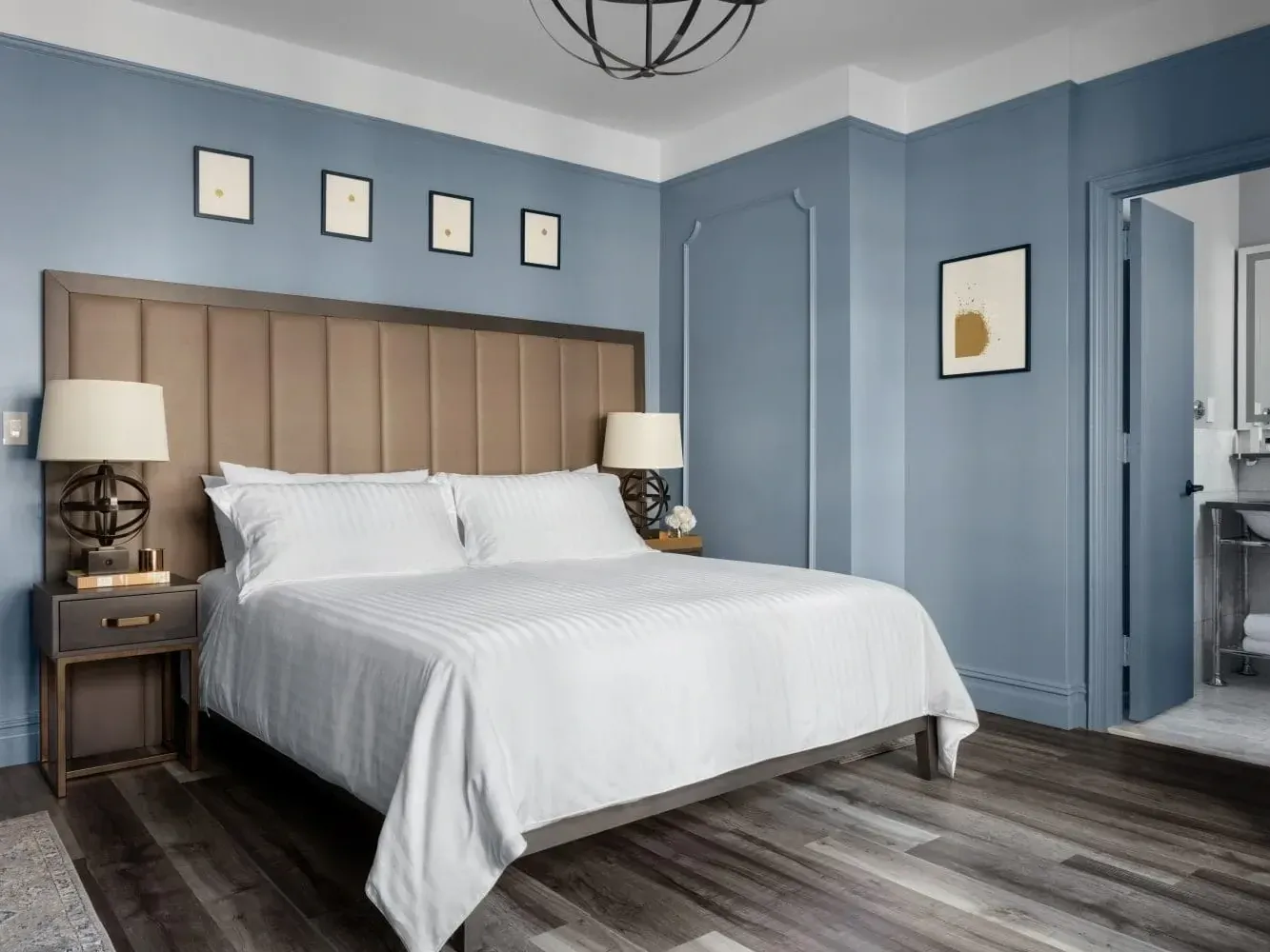 Nightstands by the cozy bed in King Room with wooden floors at Kixby Hotel