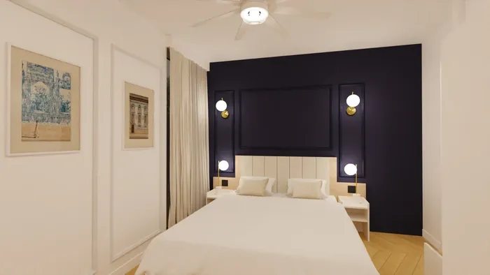 Chambre élégante avec lit blanc et mur bleu nuit de Les Sources Callou.