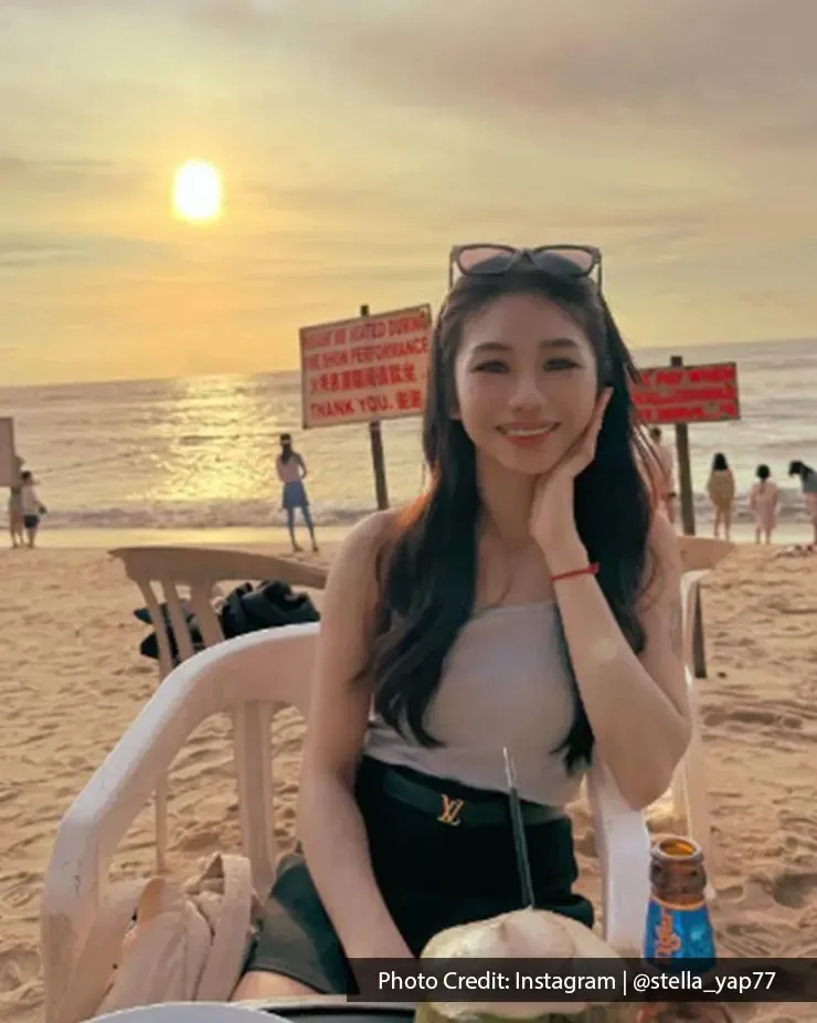 Woman enjoying a coconut drink at BoraBora in Batu Ferringhi Penang during sunset.