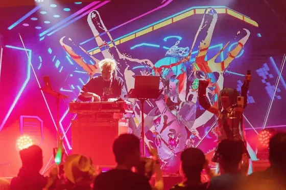 Crowd enjoying an energetic electronic music set with vibrant lighting at the Northern International Audio Visual Show