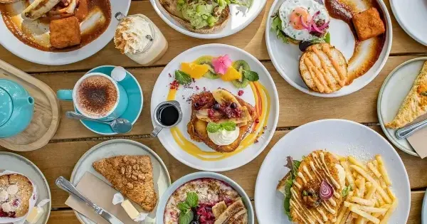 A cafe table topped with coffee and baked goods