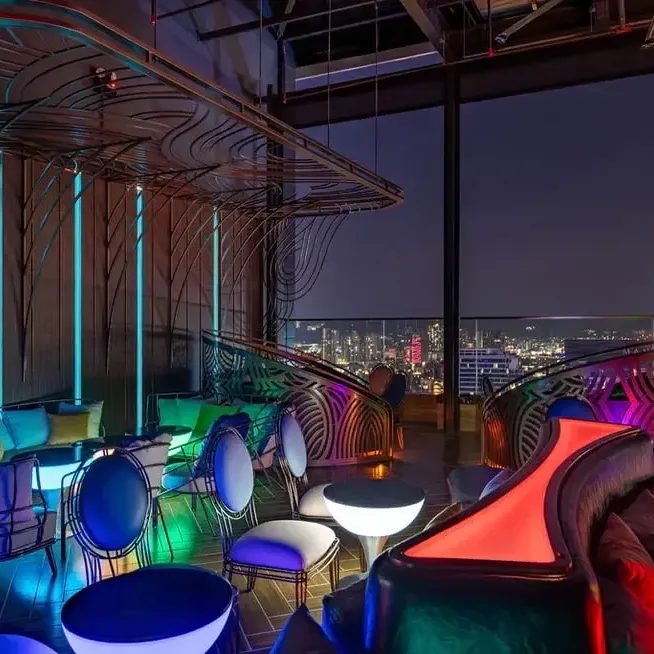 Cozy seating area at Satellite Restaurant & Bar with colourful lights - Lexis Hotels & Resorts