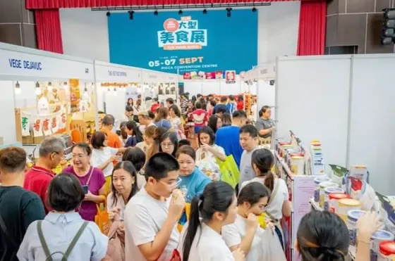 Visitors browsing packed aisles filled with food vendors and displays at the TLM Food Expo