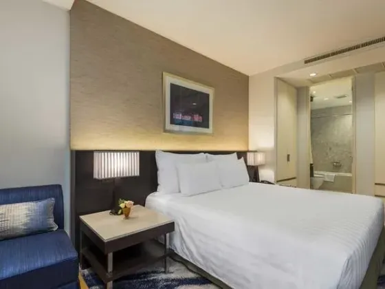 Bed in a one bedroom suite at Emporium Suites by Chatrium