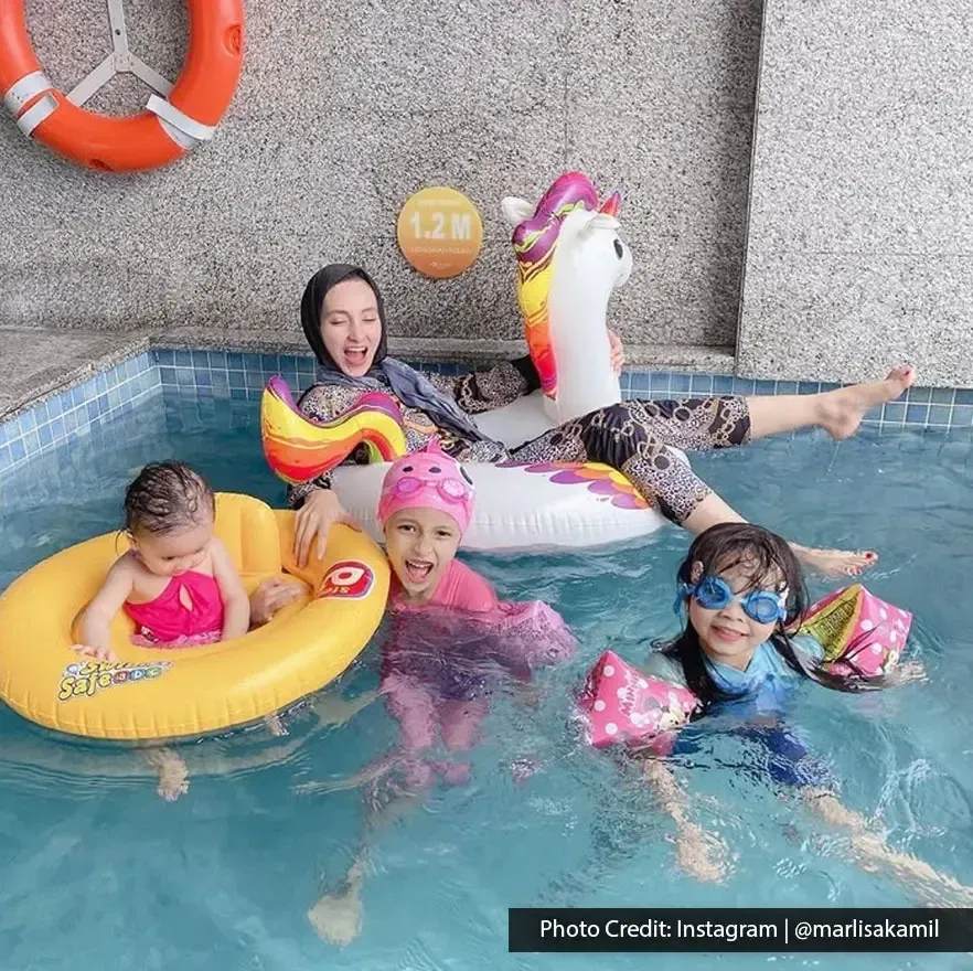 Family enjoying pool time with floaties at Lexis Suites Penang