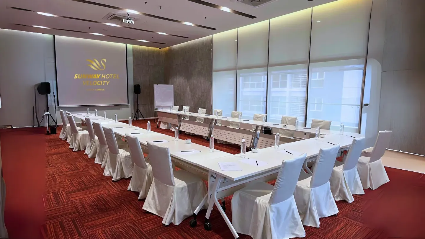 Boardroom set-up with a digital screen in a meeting room at Sunway Velocity Hotel