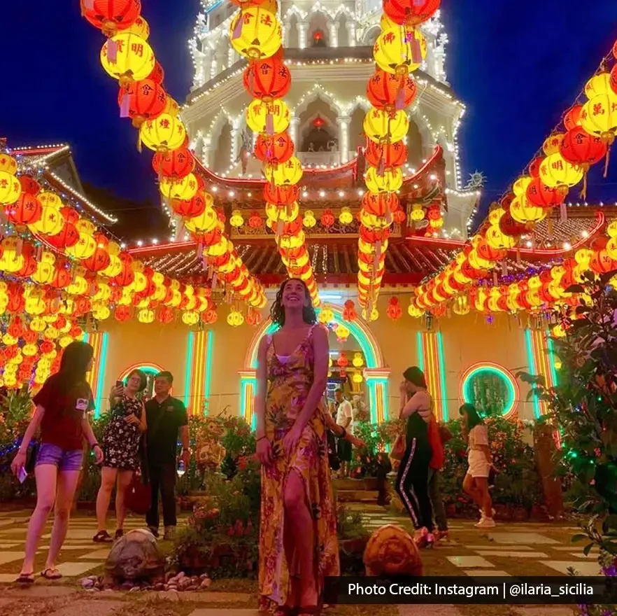Night scene with people enjoying the lantern display and pagoda lights at Kek Lok Si.