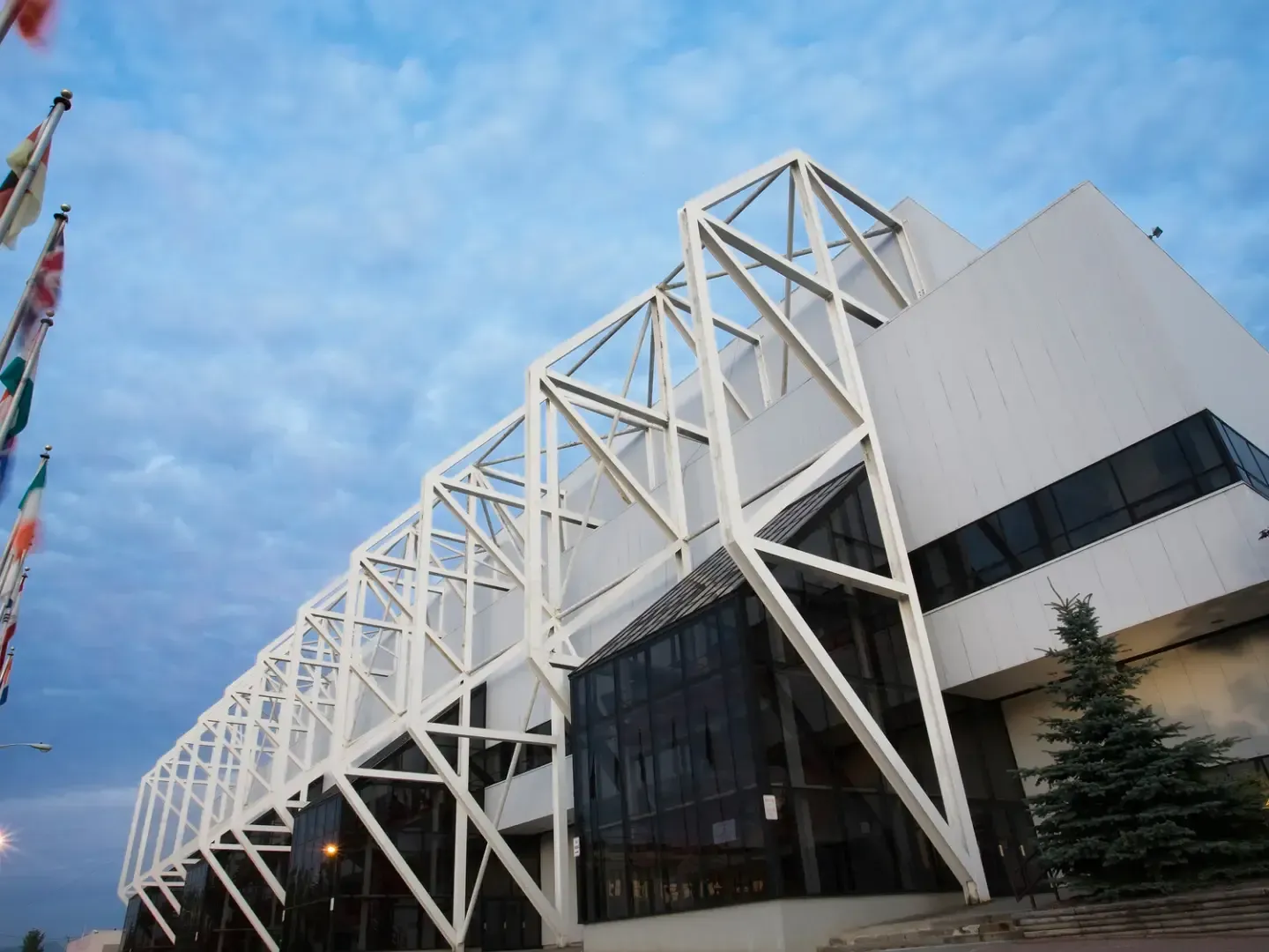 The distinctive white steel exoskeleton architecture of the Olympic Center near Lake Placid Club Grandview at dusk