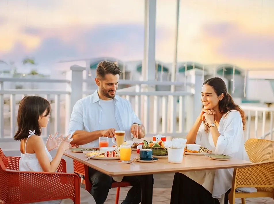 Parents and child dining outdoors at Lexis Hibiscus Port Dickson