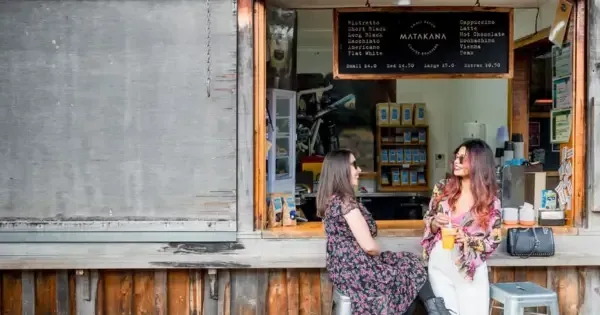 Two women enjoying a juice at Matakana Farmers Market near Auckland