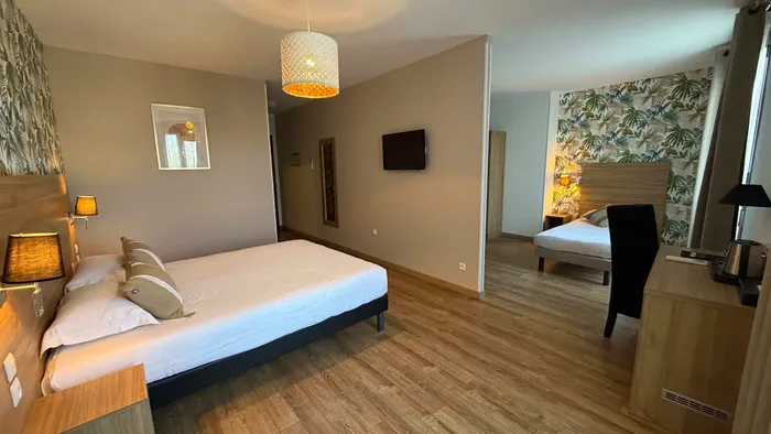 Chambre élégante avec lit et bureau au Grand Hôtel Molière.