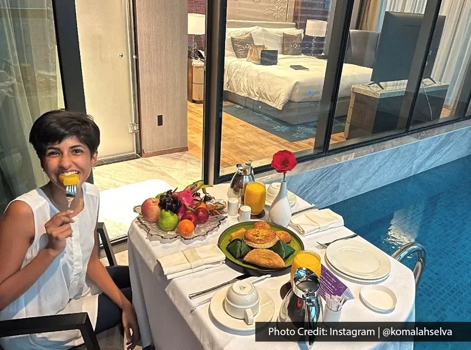 A woman enjoying her birthday staycation with inroom dining.