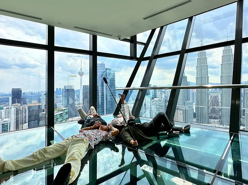 Guests experiencing the glass floor sky deck at Imperial Lexis, offering an unparalleled KLCC view.