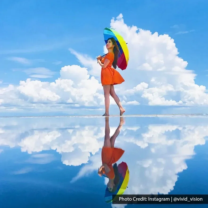 Woman with rainbow umbrella at Sky Mirror.