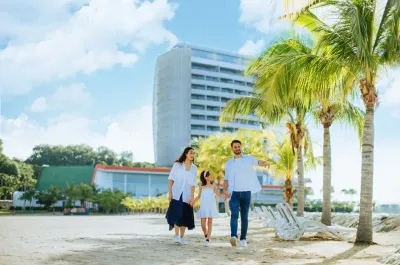 Family strolling by the beach with palm trees - Lexis Hibiscus Port Dickson