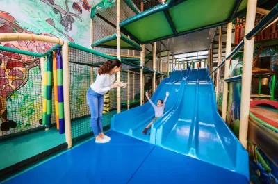 Child sliding down on indoor slide at Kidz World - Lexis Hibiscus Port Dickson