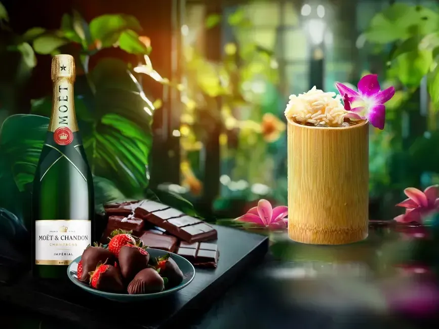 A bottle of champagne on a table accompanied by chocolate coated strawberries on the side - Imperial Lexis Kuala Lumpur