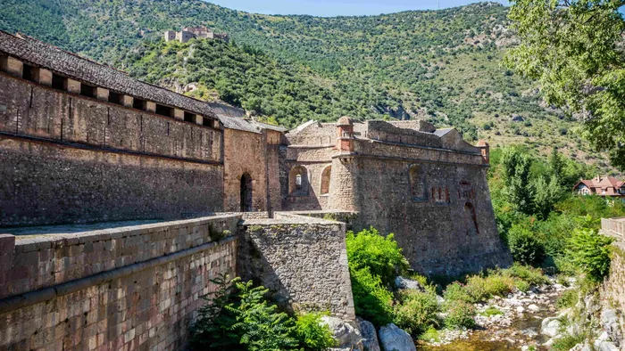 Ancient stone fortress and river in Cité Vauban at The Originals City Hotel du Parc Gravelines.