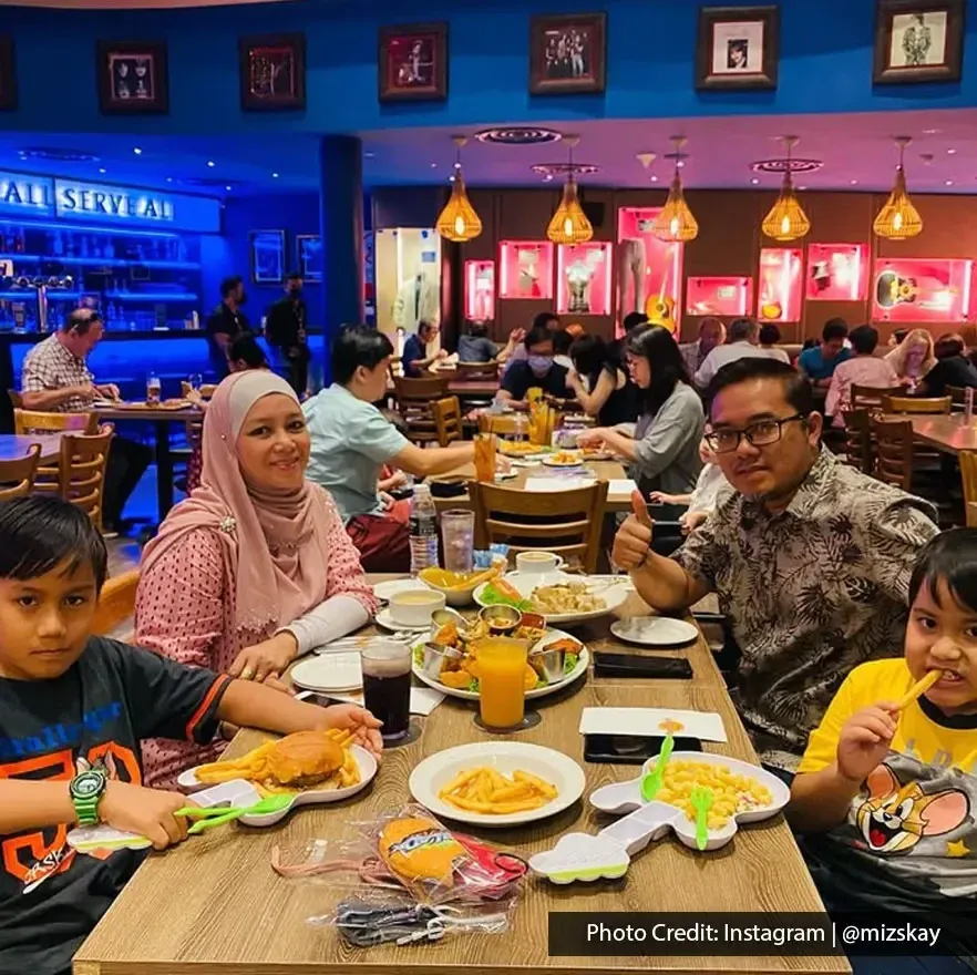 Family enjoying dinner together at Hard Rock Cafe Penang.