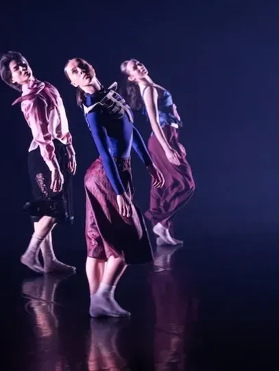 Group of dancers performing a dance routine on a stage at an event.