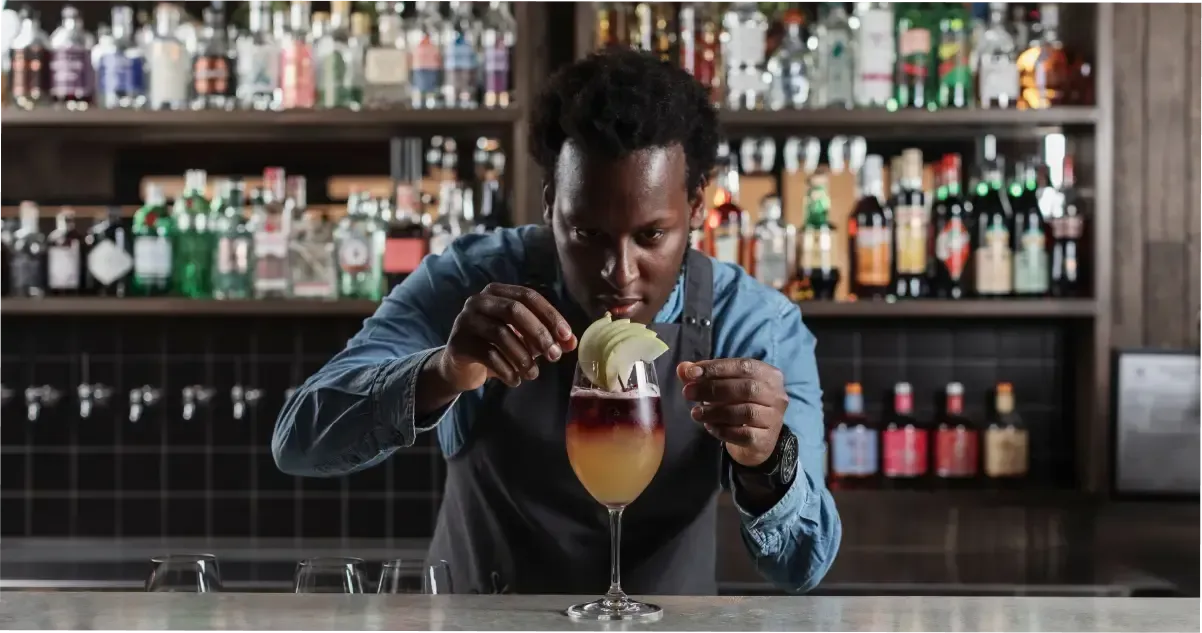 A bartender preparing a cocktail in Adelaide’s West End nightlife spot