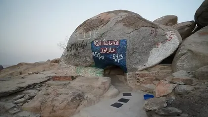 Exterior of the historic Cave of Jabal Thawr on a rocky mountain with painted inscriptions near Saja by Warwick Makkah