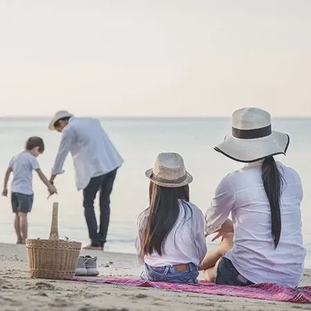 Family enjoying a beach staycation in Port Dickson during Merdeka weekend