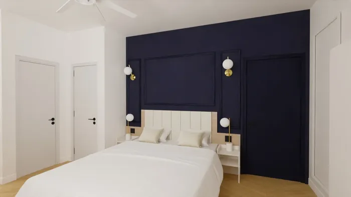 Chambre à coucher élégante avec lit blanc et mur bleu Les Sources Callou