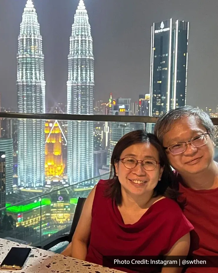 A couple poses happily in front of the Petronas Towers, capturing a memorable moment during their night visit in KL.