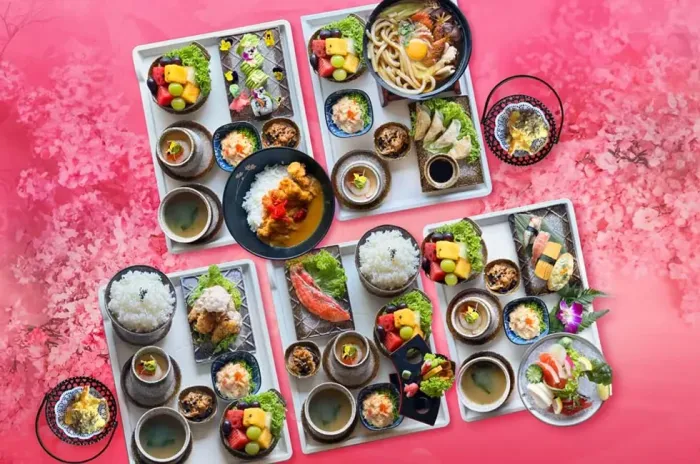 An assortment of Japanese dishes arranged on trays - Lexis Suites Penang