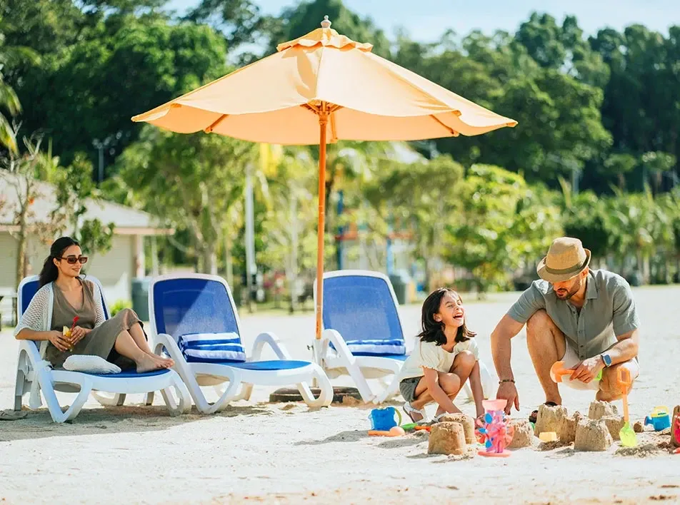 Father and daughter building sandcastle - Lexis Hibiscus